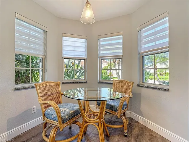 Dining area featuring a textured wall and wood finished floors