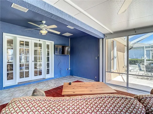 Sunroom with Wall mount TV, and ceiling fan, french doors, and a patio area