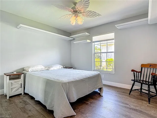 Bedroom with wood finished floors and a ceiling fan