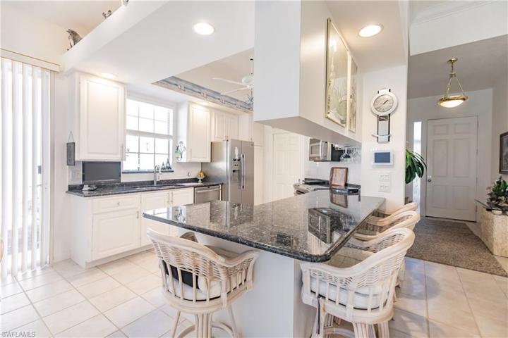 Kitchen opens to great room and dining areas.