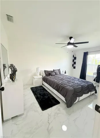 Bedroom with marble finish flooring