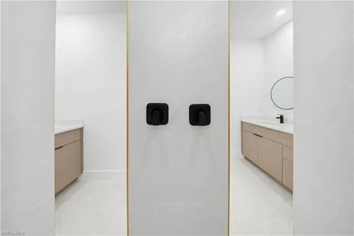 Bathroom with vanity, light tile patterned floors, and recessed lighting