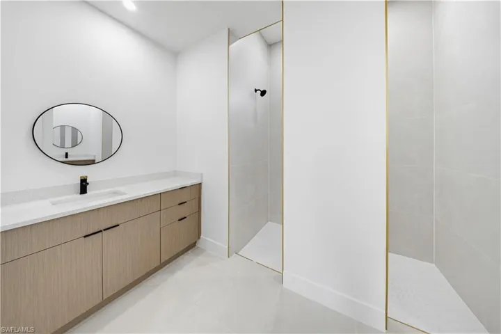 Full bathroom with walk in shower, vanity, recessed lighting, and light tile patterned flooring