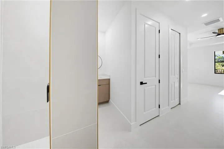 Hall featuring baseboards and recessed lighting