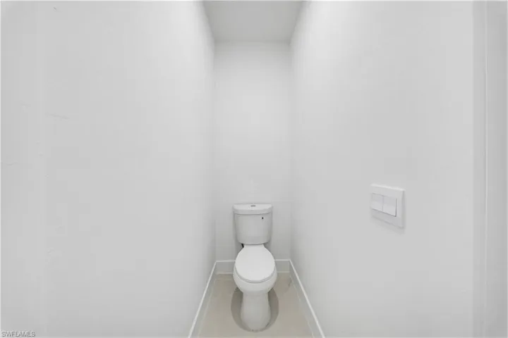 Bathroom with toilet and baseboards