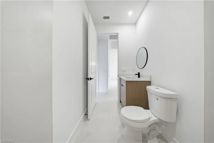 Bathroom featuring vanity and toilet