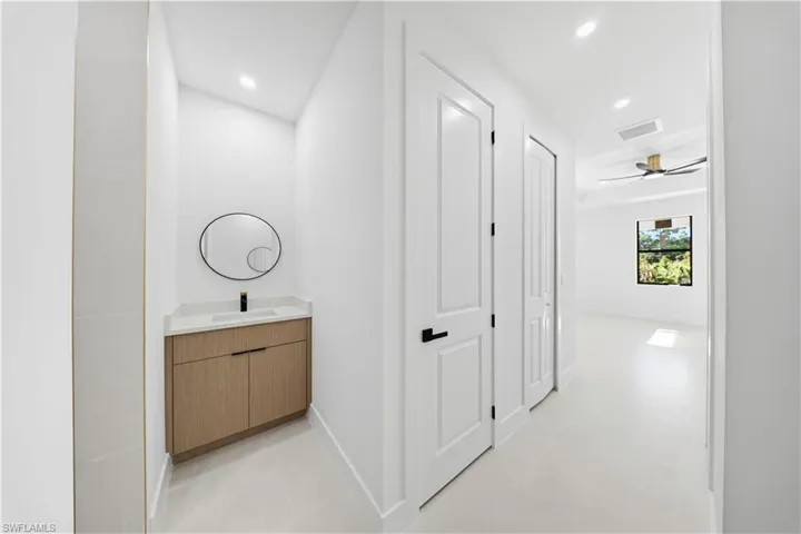 Hallway with recessed lighting and light tile patterned flooring