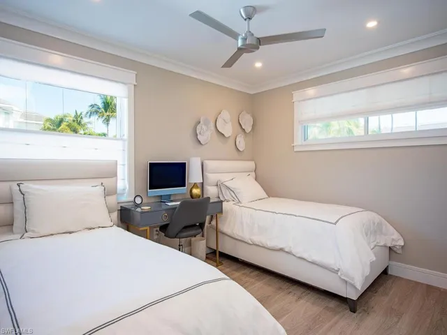 Bedroom featuring light wood finished floors, ornamental molding, recessed lighting, ceiling fan, and an office area