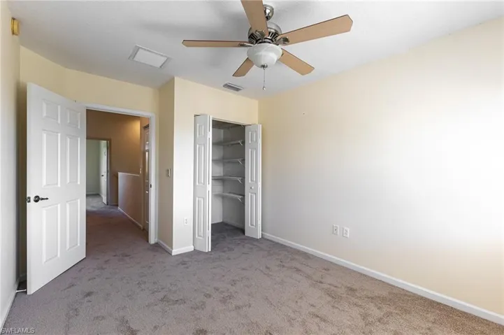 Unfurnished bedroom featuring carpet and a ceiling fan