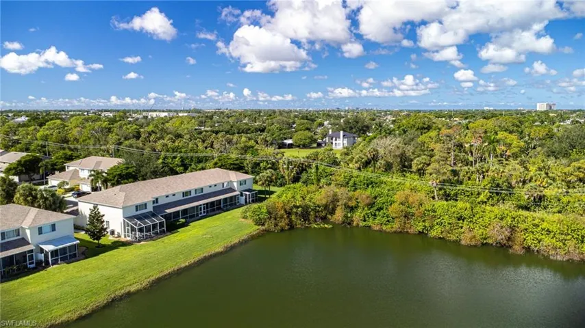 Aerial view of property and surrounding area featuring a large body of water