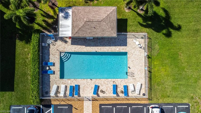 View of subject property with a pool area