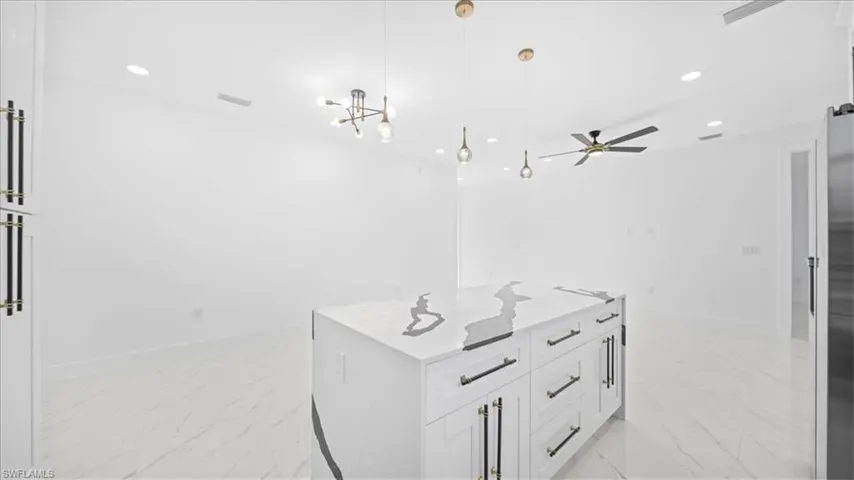 Full bath with recessed lighting, light marble finish flooring, vanity, and ceiling fan