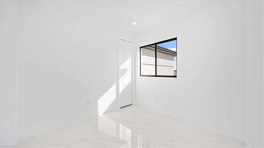 Empty room featuring recessed lighting and light marble finish flooring