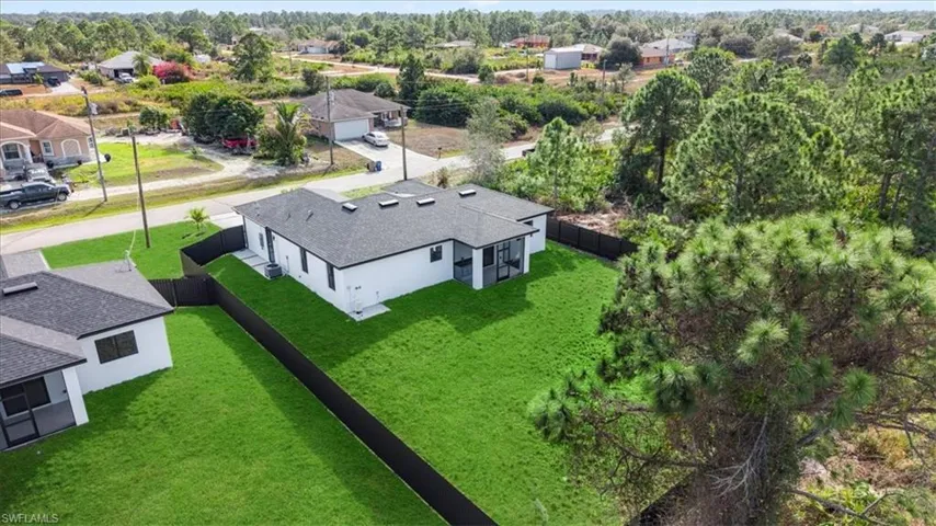 Aerial perspective of suburban area featuring a tree filled landscape