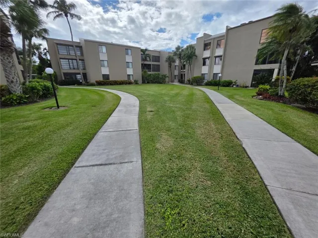 View of property's community with a yard