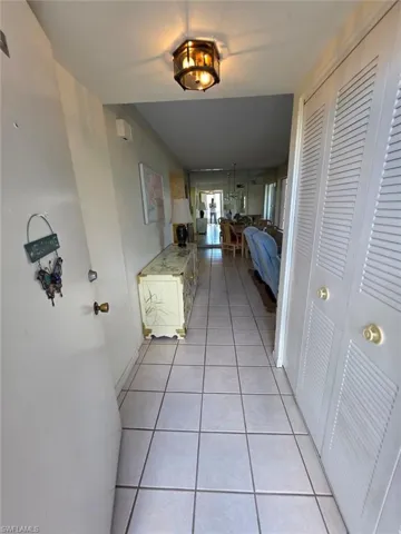 Hallway featuring light tile patterned floors