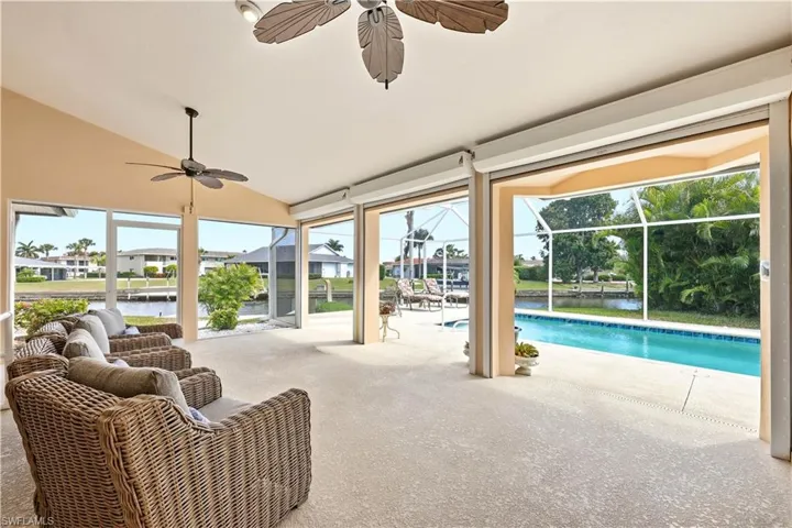 Saltwater pool, Large under truss screen enclosed lanai, Electric Roll-down shutters, and a water view.