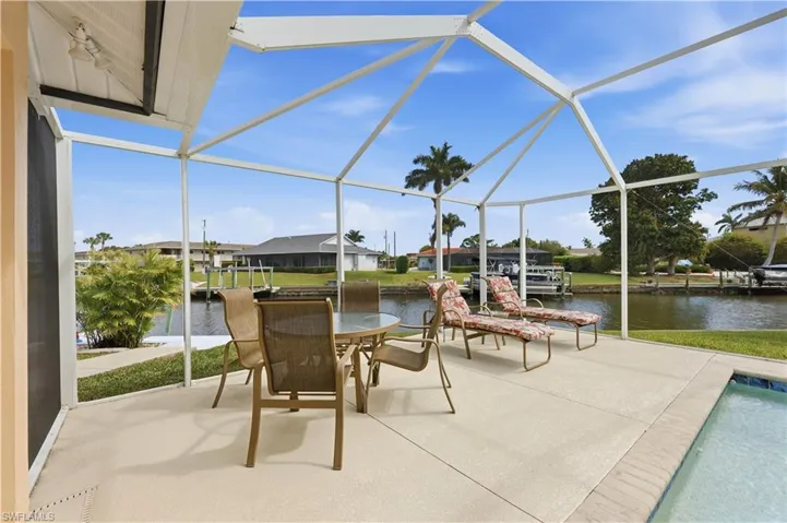 Sunning area by the pool with a view of the canal.