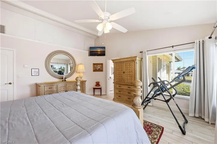 Master Bedroom Suite featuring light tile flooring, vaulted ceiling, and a ceiling fan