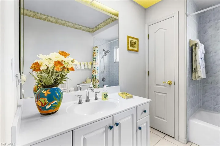Second Full bath with vanity, light tile patterned floors, and shower / tub combo