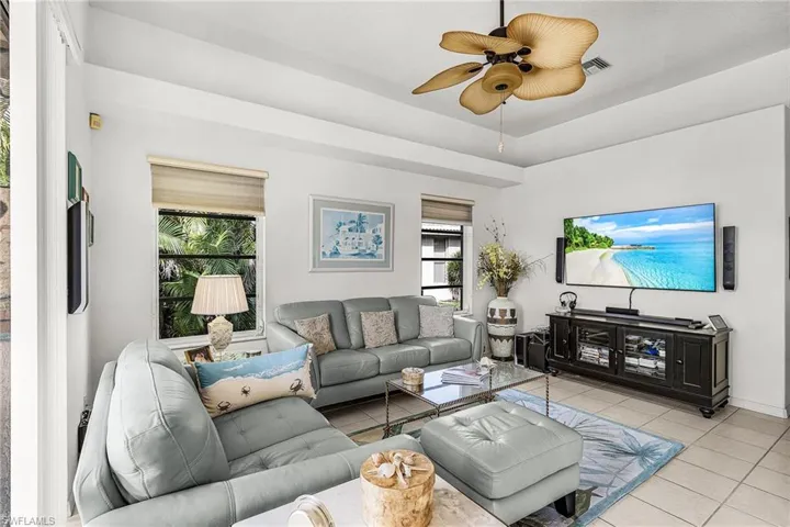 Family Room featuring a ceiling fan  Slilders to the lanai
