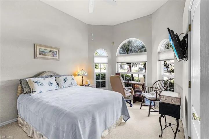 Guest Bedroom featuring light carpet and ceiling fan