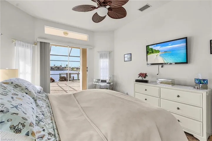 Bedroom featuring access to exterior and a ceiling fan