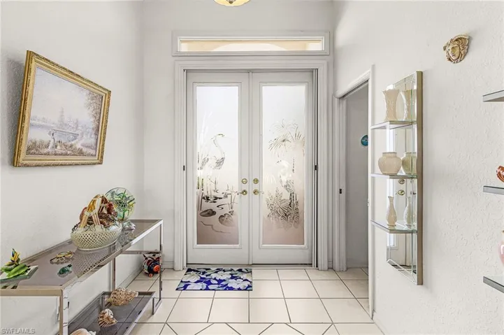 Entrance foyer with light tile porcelain patterned floors