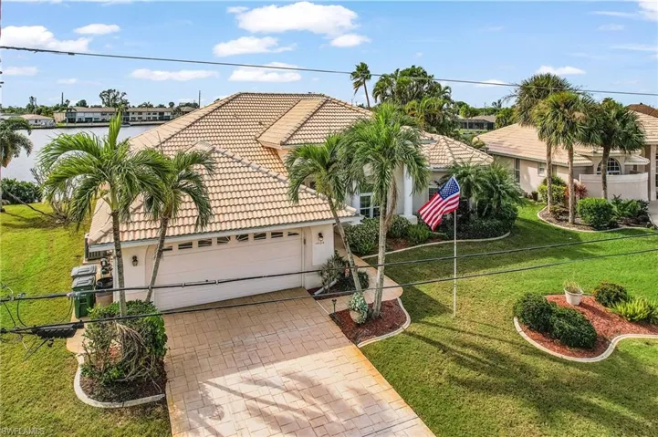 Front yard, decorative driveway, two car attached garage