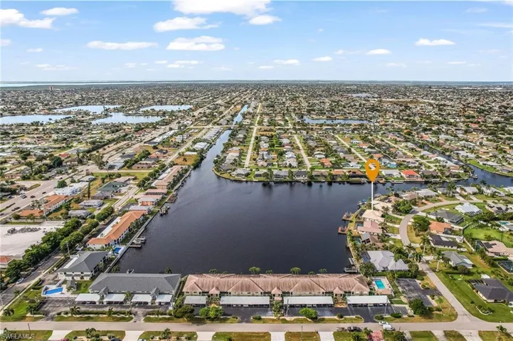 Aerial view of property and surrounding area featuring water view