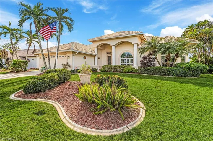 Gulf Access house featuring a paver driveway, stucco siding, a tiled roof, and a 2 car garage