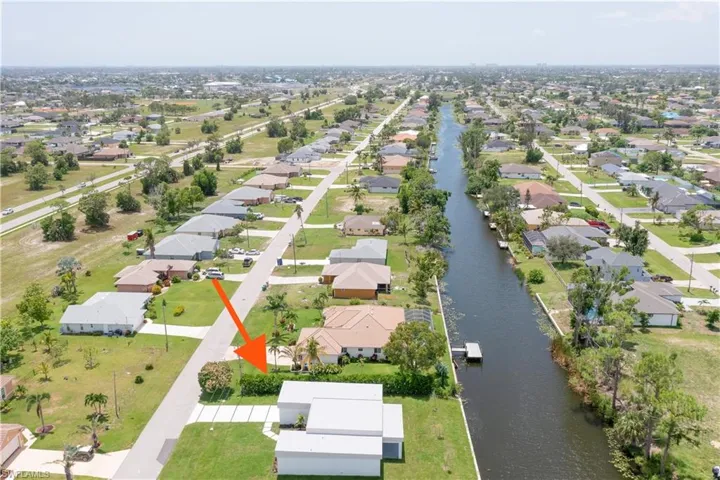 Aerial overview of property's location with nearby suburban area and a large body of water