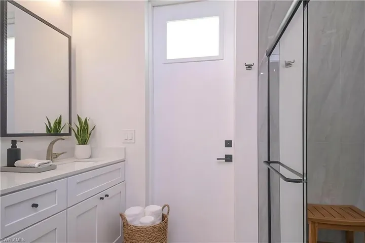 Full bathroom featuring vanity and a stall shower