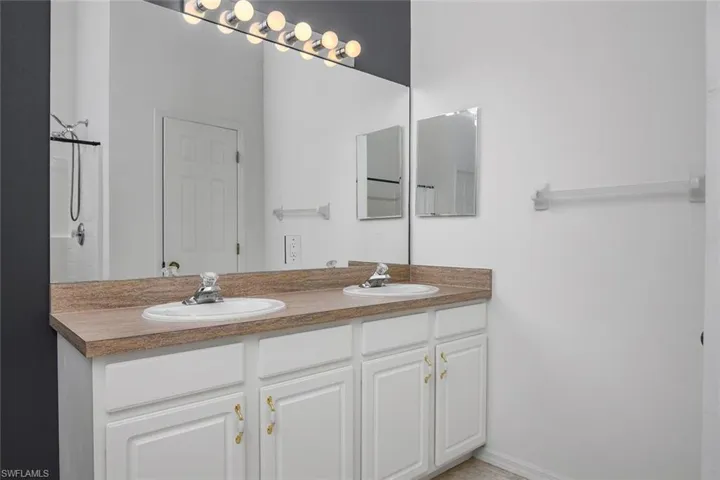 Bathroom with vanity and a shower