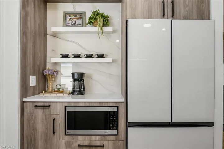 Bar featuring white refrigerator
