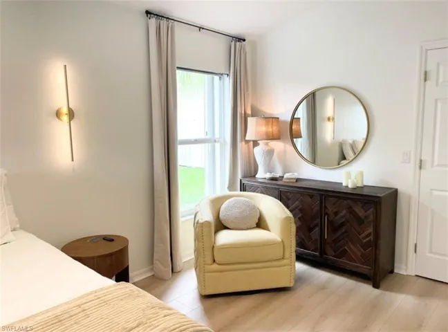 Bedroom featuring light wood-type flooring and multiple windows