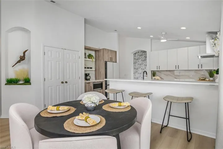 Dining space featuring ceiling fan, sink, and light hardwood / wood-style floors