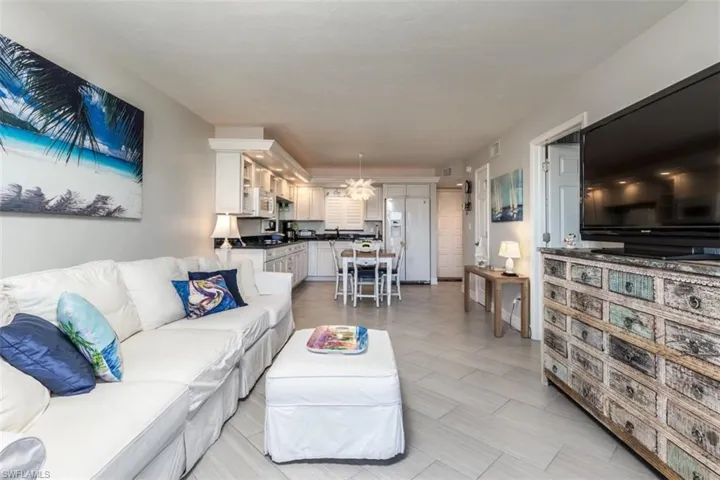 Living room featuring sink and a notable chandelier