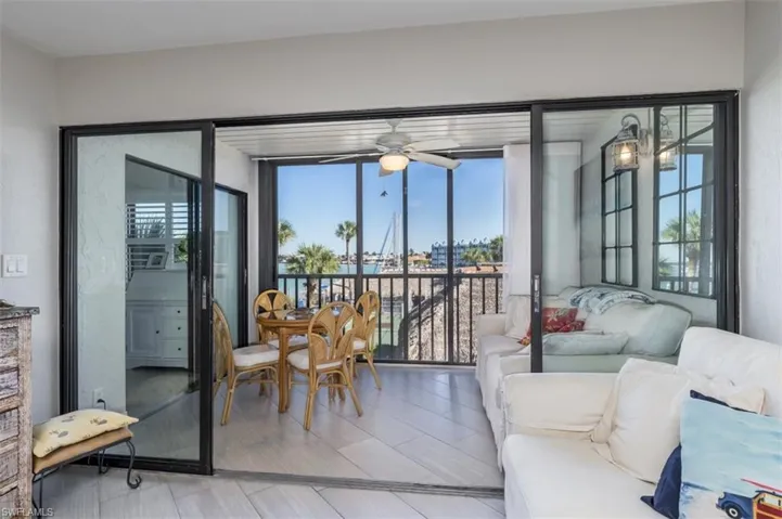Sunroom with a wealth of natural light and ceiling fan