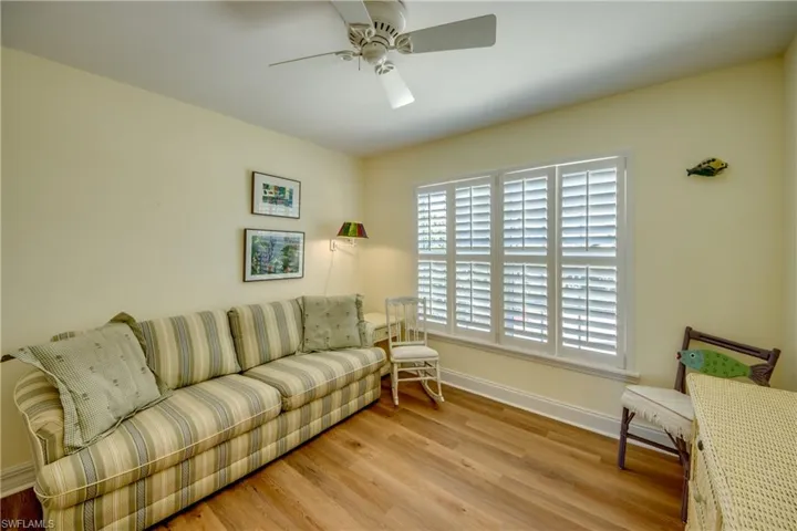 Living room featuring light wood-type flooring and a ceiling fan