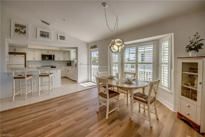 Dining room with vaulted ceiling and light wood finished floors