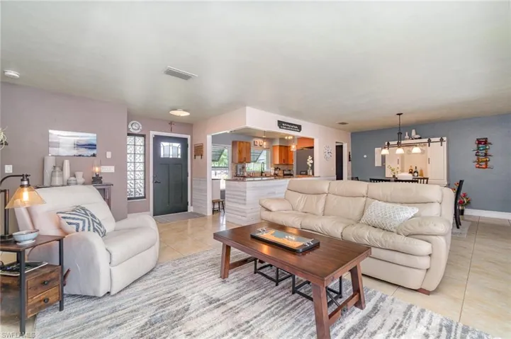 Tiled living room with a chandelier