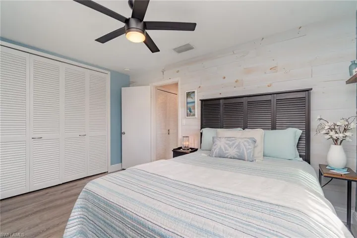 Bedroom featuring ceiling fan, light hardwood / wood-style floors, and a closet