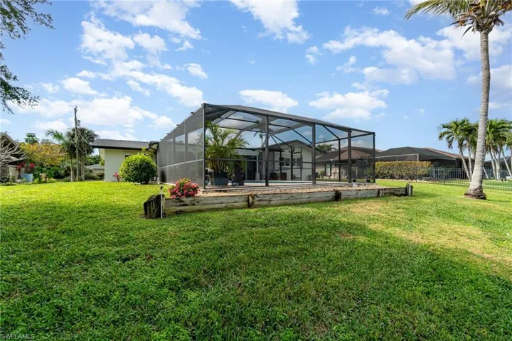View of yard featuring glass enclosure