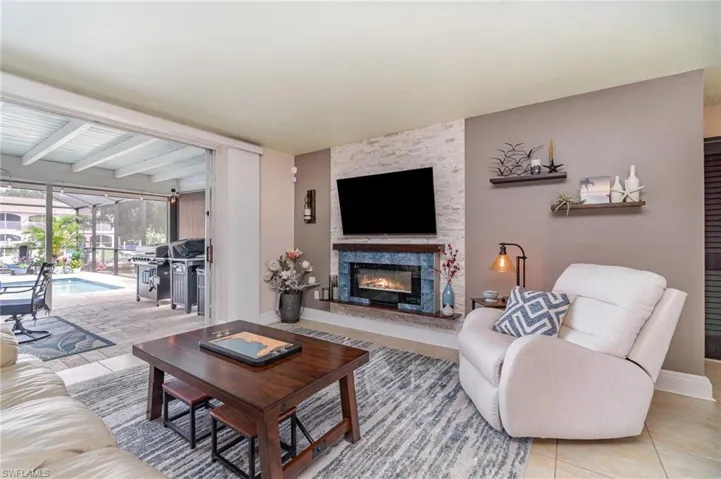 Tiled living room with a fireplace and beamed ceiling