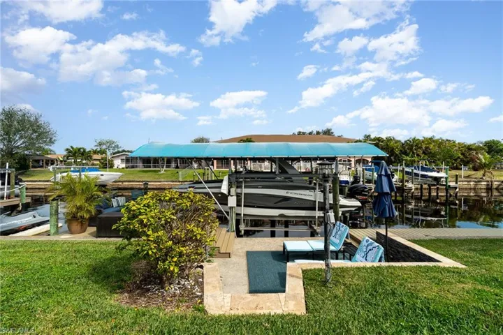 Dock area with a yard and a water view