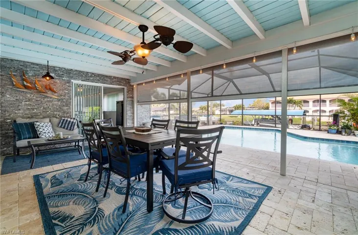 View of patio / terrace featuring ceiling fan, an outdoor living space, and a lanai