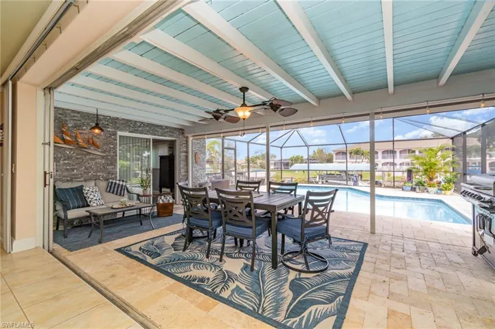 Sunroom / solarium with beamed ceiling and ceiling fan