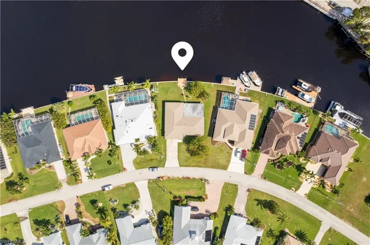Birds eye view of property with a water view