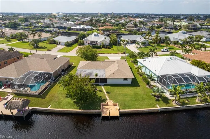 Birds eye view of property with a water view